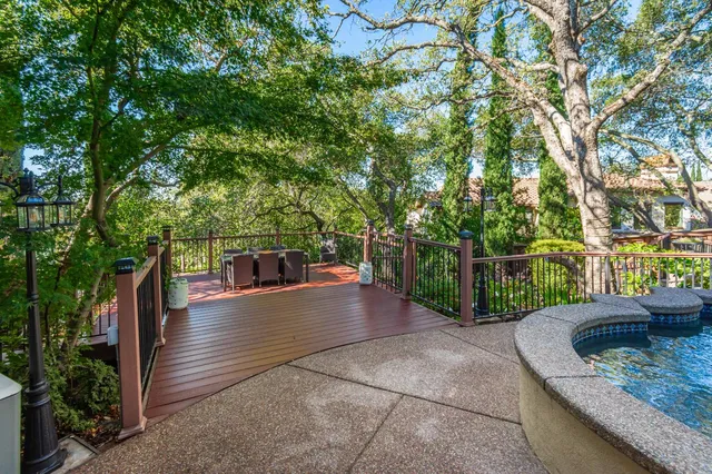 a view of a patio with couches table and chairs and potted plants