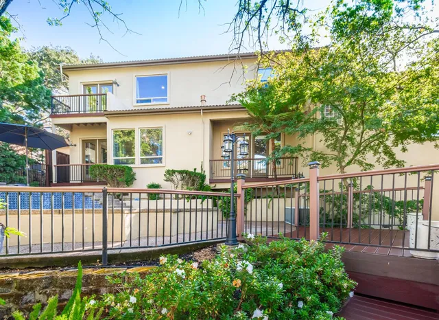 an aerial view of a house with garden space and a patio