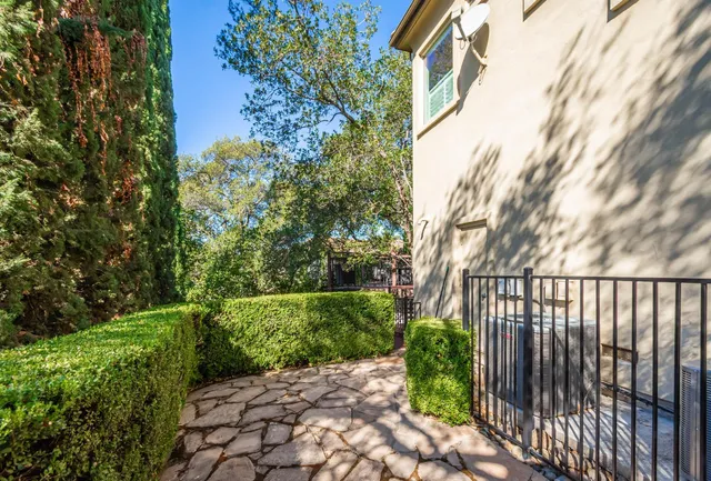 an aerial view of a house with garden space and street view