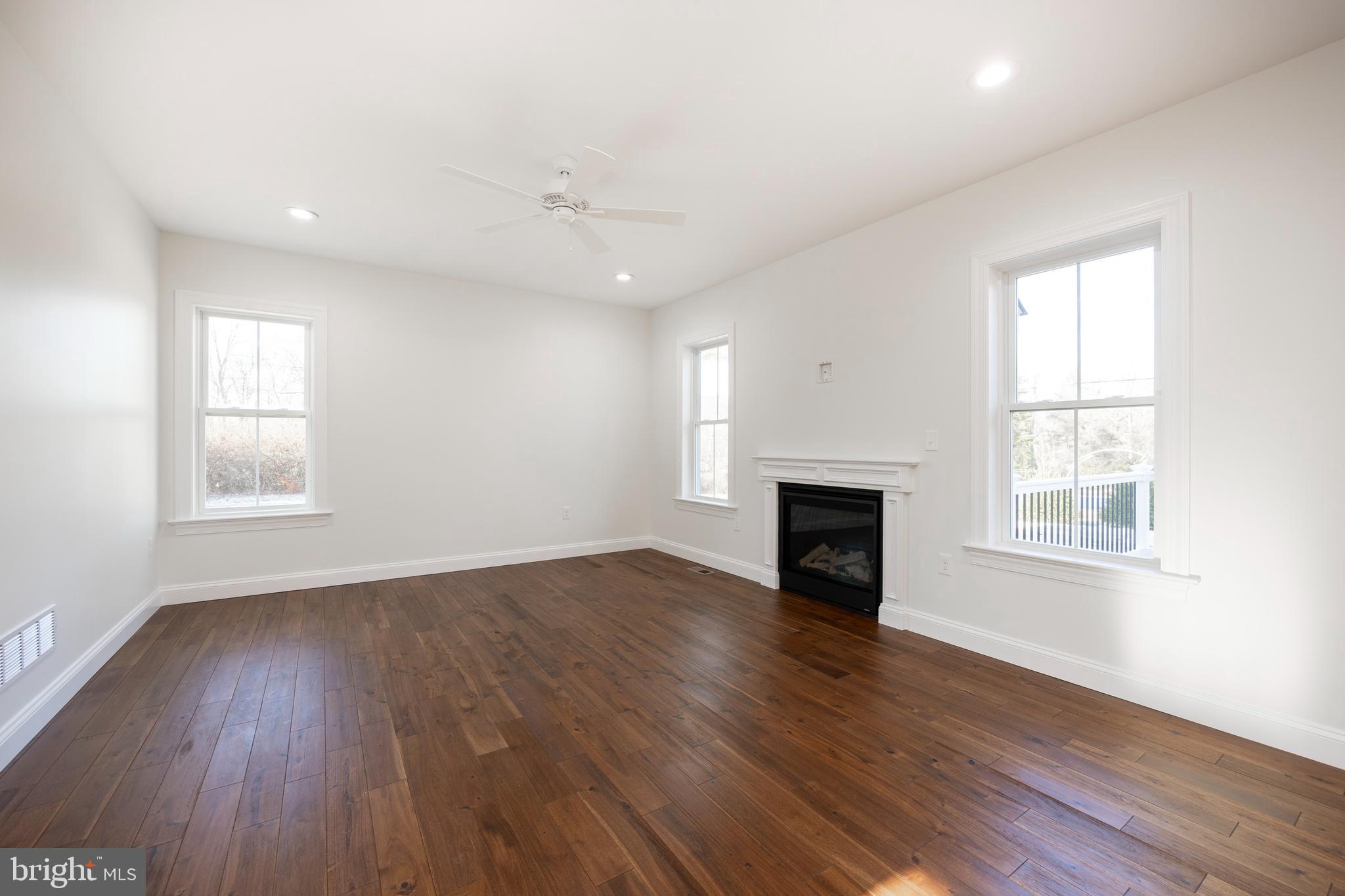 660 Little Conestoga Road Downingtown, PA 19335 - Photo 21 of 56 an empty room with wooden floor fireplace and windows