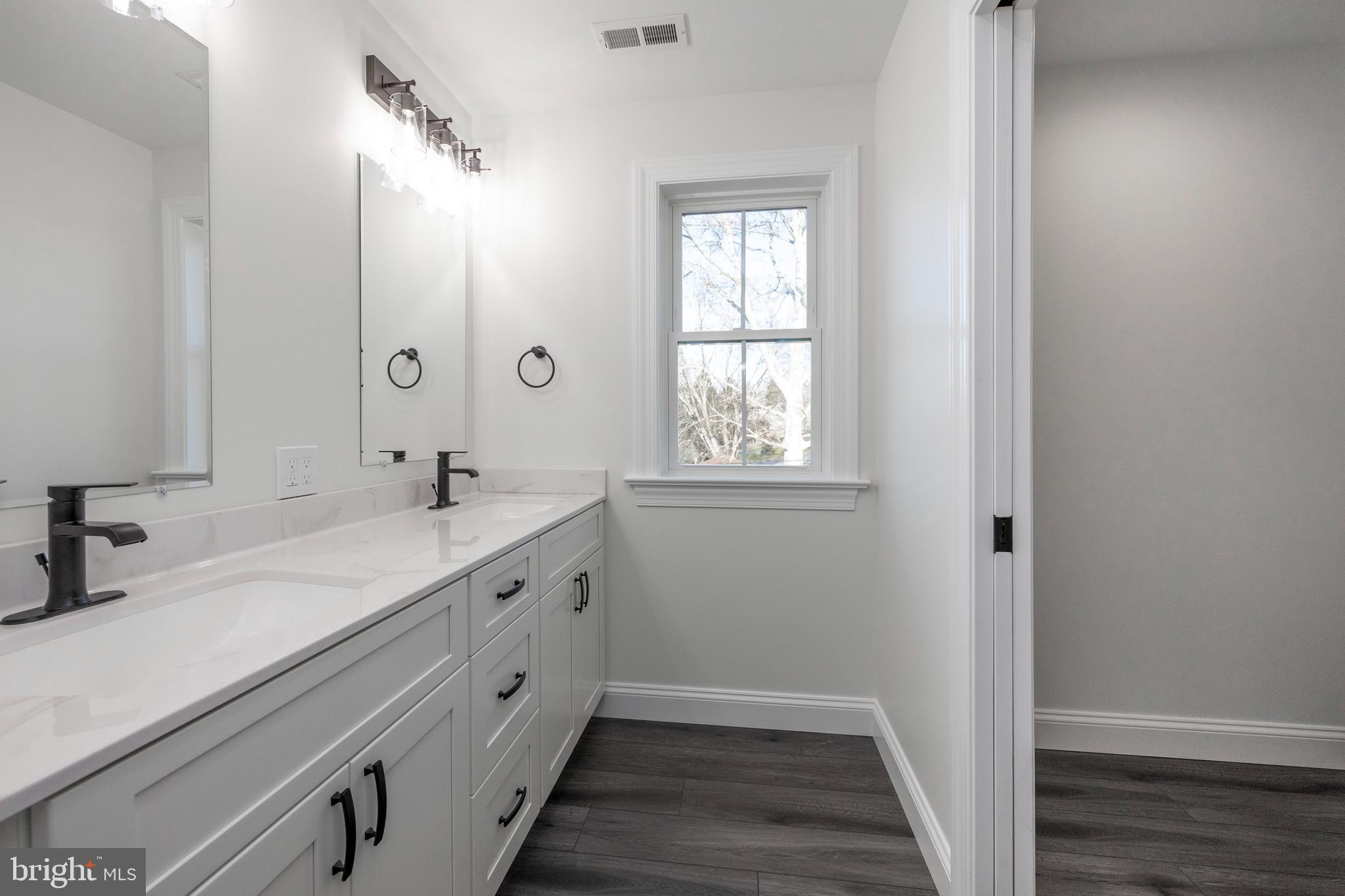 660 Little Conestoga Road Downingtown, PA 19335 - Photo 32 of 56 a spacious bathroom with a double vanity sink a mirror and a shower