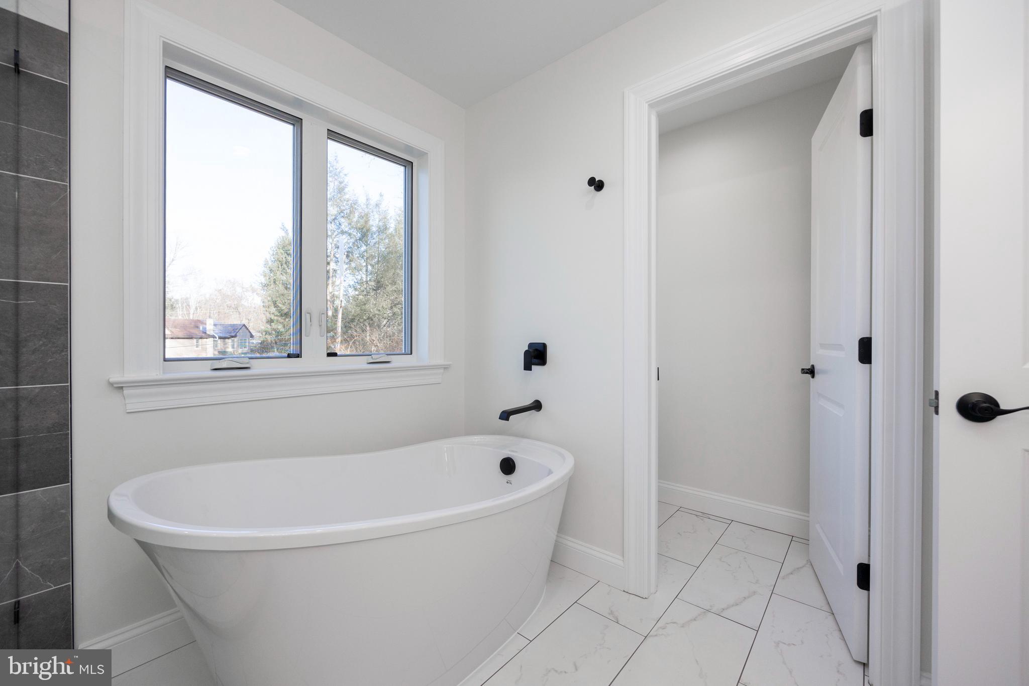 660 Little Conestoga Road Downingtown, PA 19335 - Photo 34 of 56 a white bath tub sitting next to a window