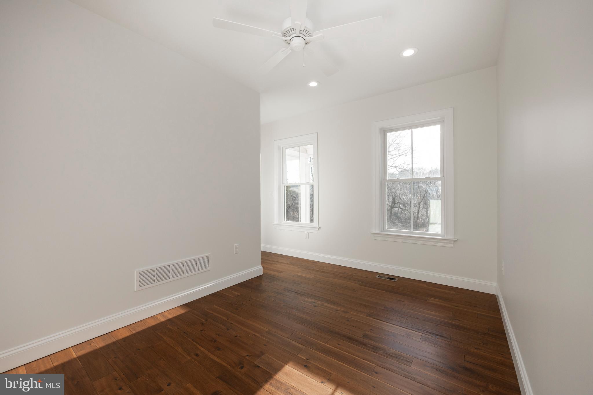660 Little Conestoga Road Downingtown, PA 19335 - Photo 37 of 56 an empty room with wooden floor and windows