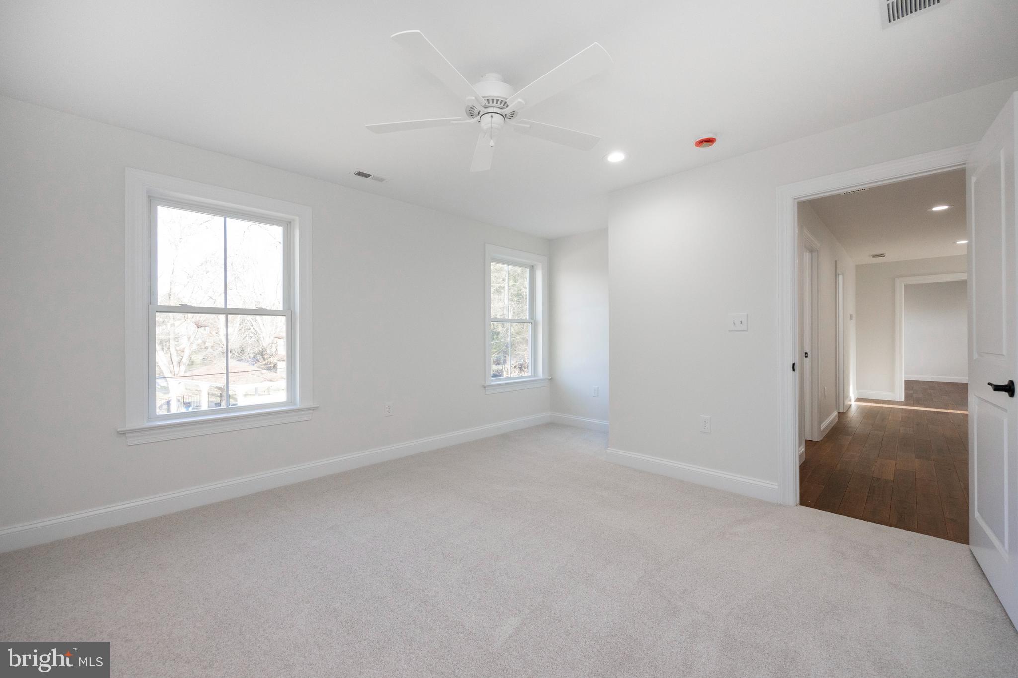 660 Little Conestoga Road Downingtown, PA 19335 - Photo 44 of 56 an empty room with windows and ceiling fan