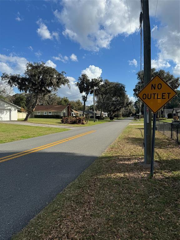 Cove Road Tavares, FL 32778 - Photo 13 of 16 a view of a yard with an house and car parked on the road