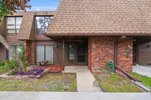 front view of a brick house with a small yard