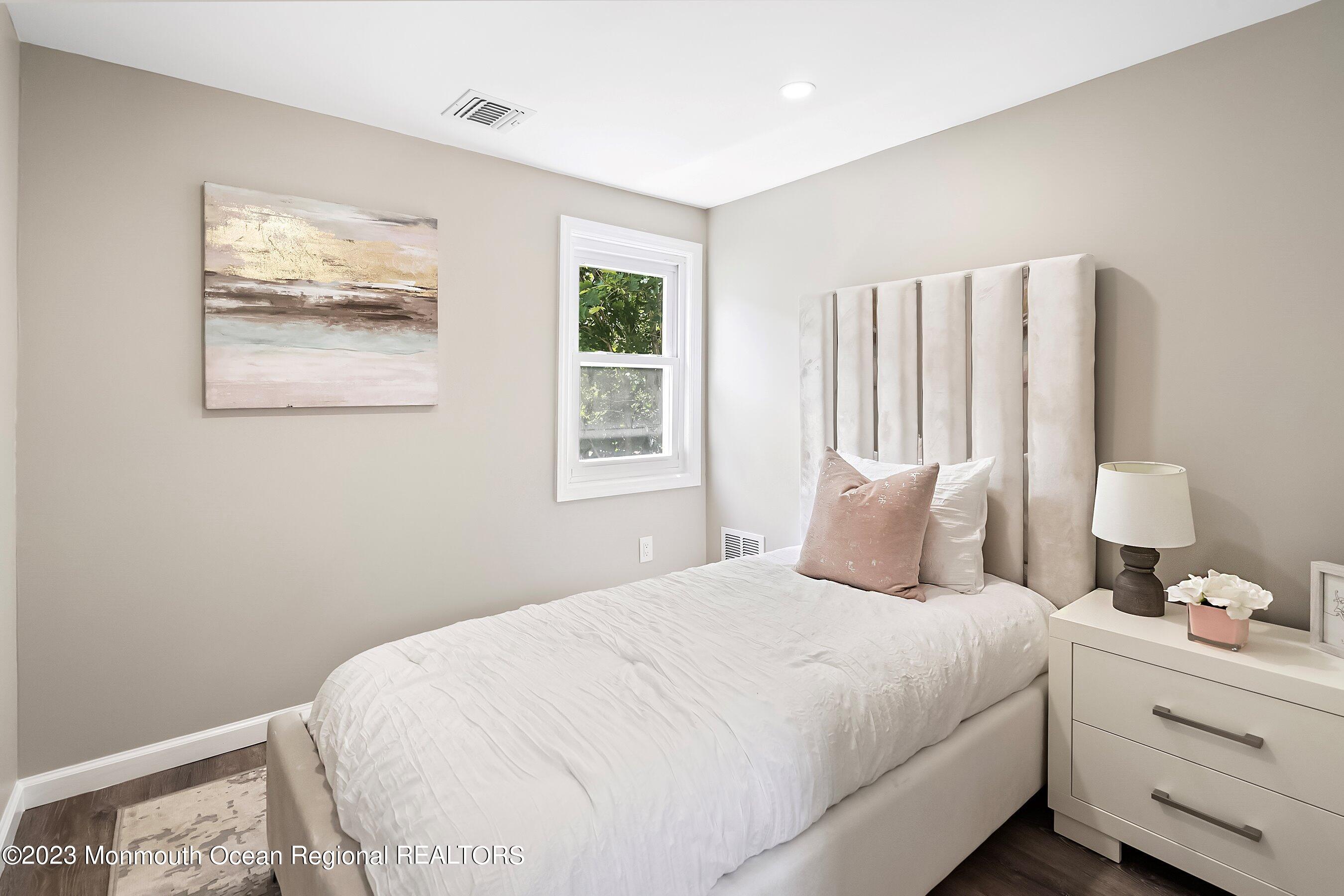 73 Main Street Englishtown, NJ 07726 - Photo 11 of 14 a bedroom with a bed and a painting on the wall