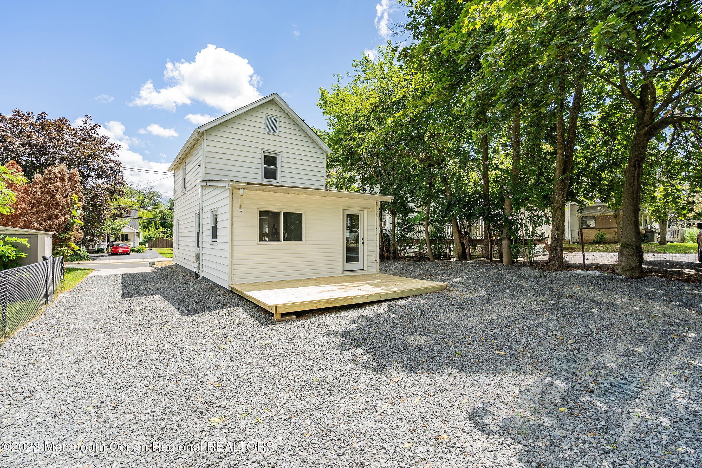 73 Main Street Englishtown, NJ 07726 - Photo 13 of 14 a front view of a house with a yard and garage