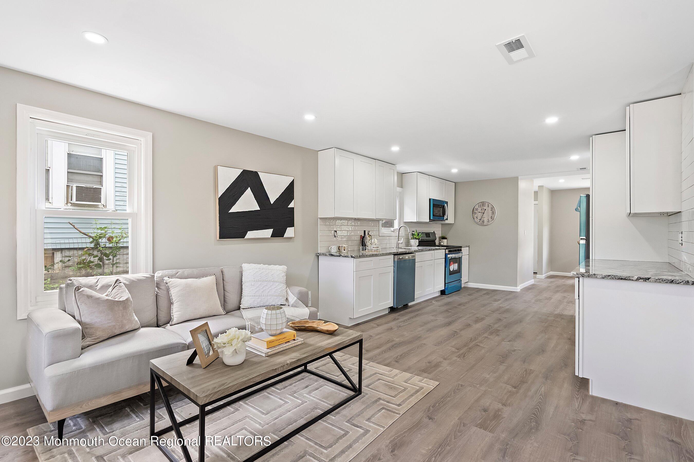 73 Main Street Englishtown, NJ 07726 - Photo 6 of 14 a living room with furniture and kitchen view