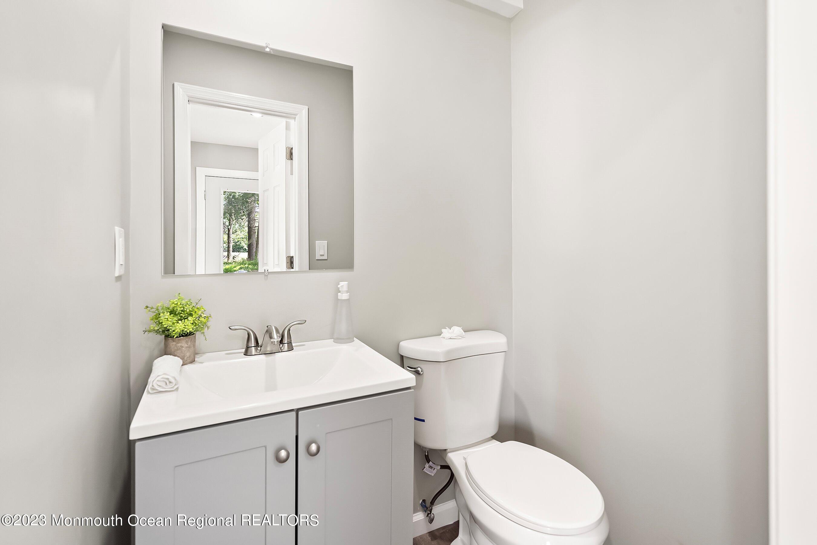 73 Main Street Englishtown, NJ 07726 - Photo 9 of 14 a bathroom with a sink a toilet and mirror