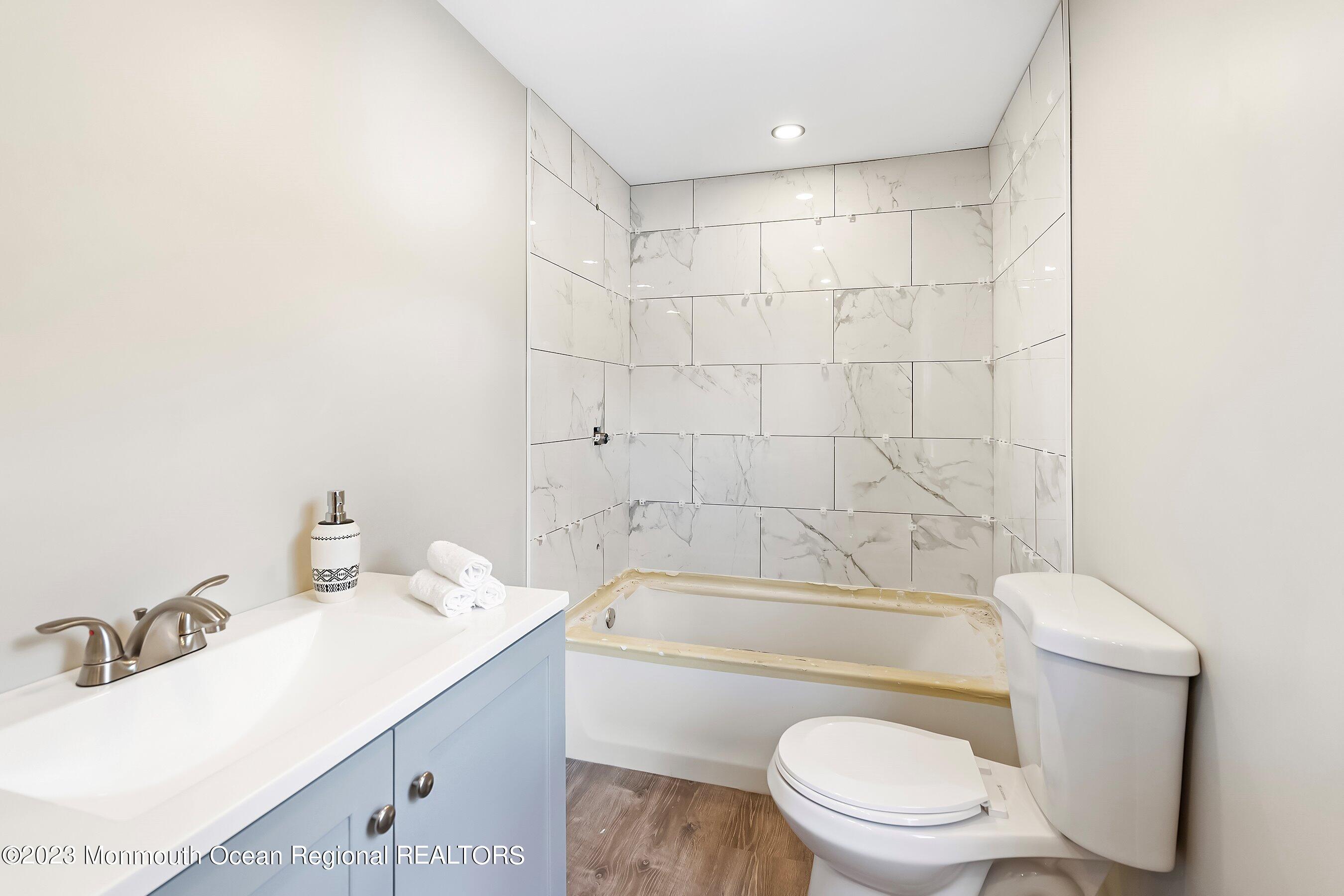 73 Main Street Englishtown, NJ 07726 - Photo 10 of 14 a bathroom with a sink a toilet and shower