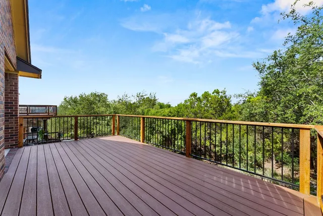 a view of balcony with wooden floor and fence