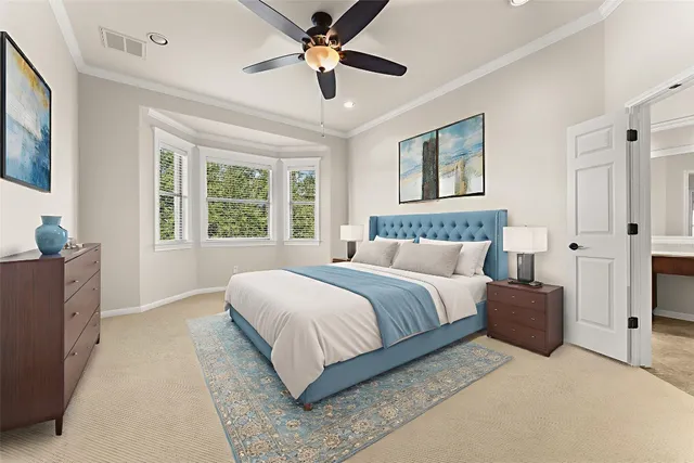 a bedroom with a large bed and a chandelier