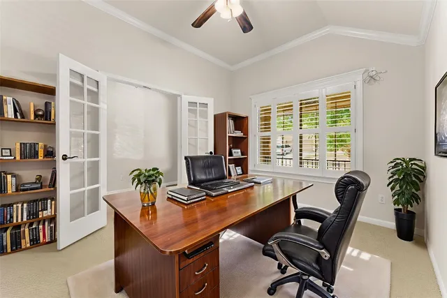 a view of a workspace with furniture and a window