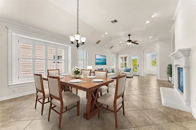 a view of a dining room with furniture and a chandelier
