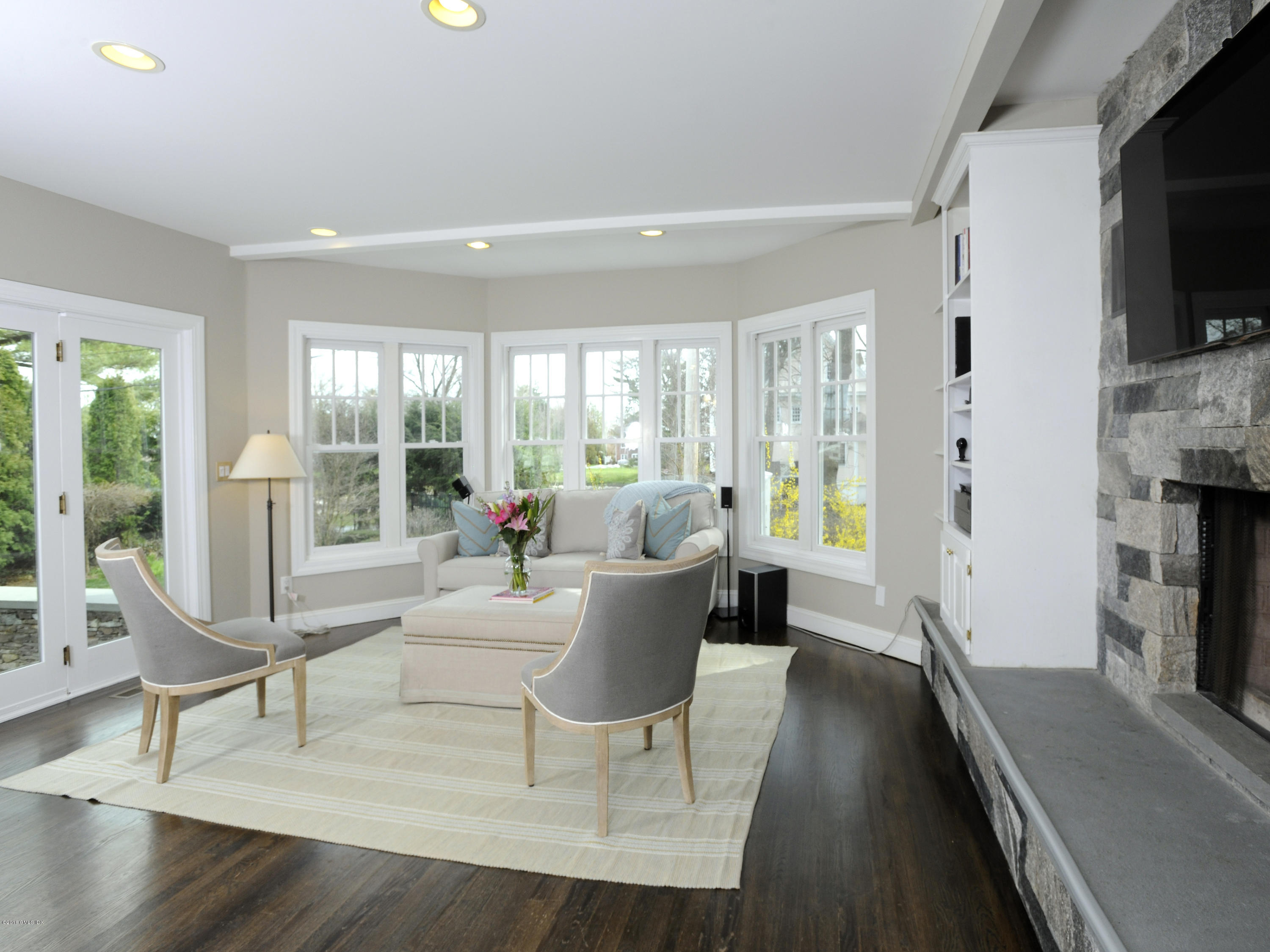 23 Willowmere Avenue Riverside, CT 06878 - Photo 5 of 21 a living room with fireplace furniture and a flat screen tv