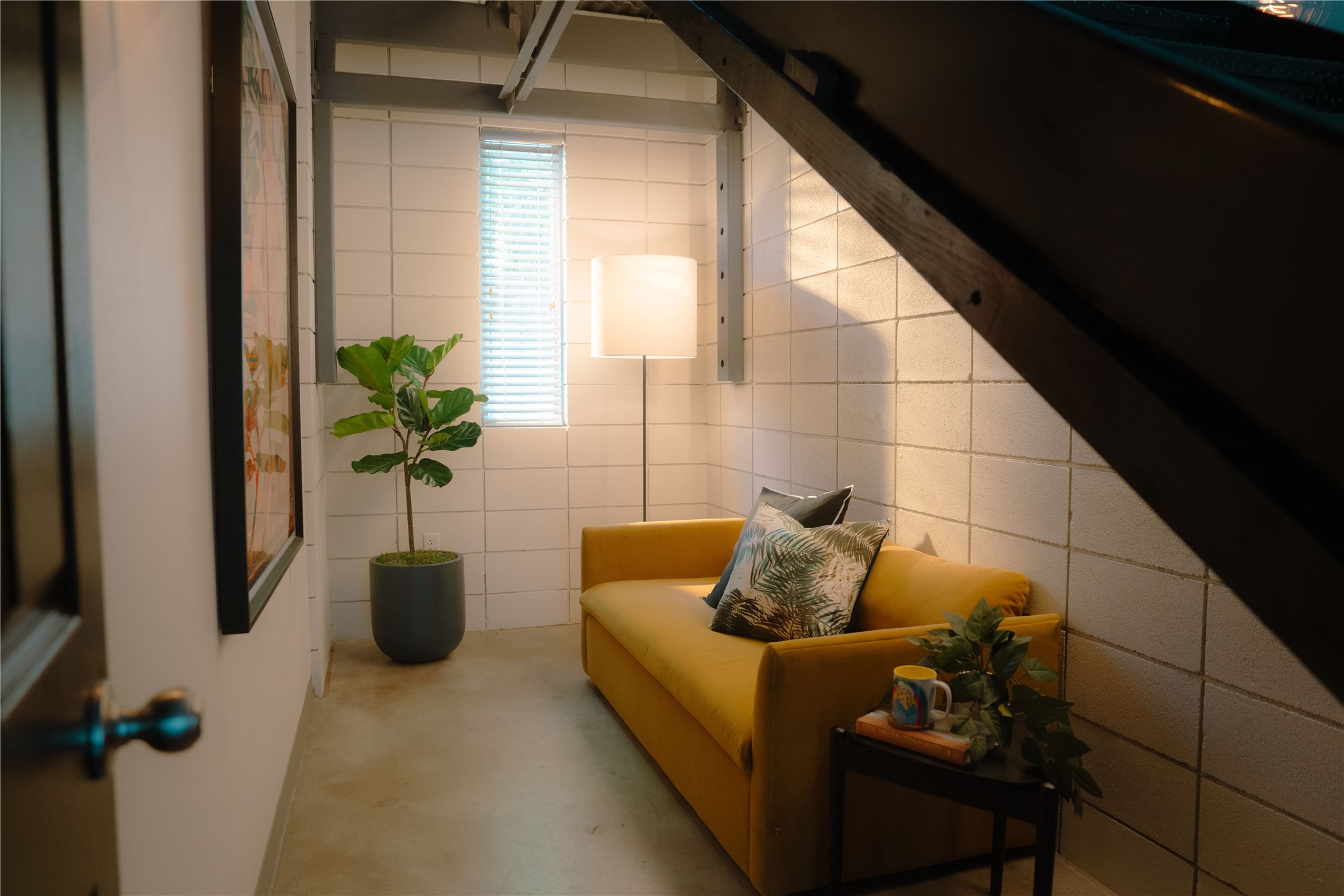 4801 South Congress Avenue, Unit H5 Austin, TX 78745 - Photo 10 of 39 Living area with tile walls and concrete flooring