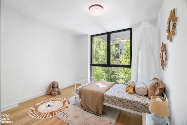 a bedroom with bed and a window