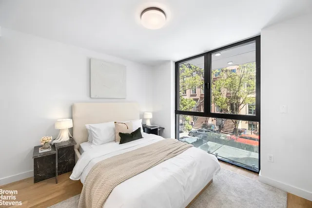 a bedroom with a large bed and a large window