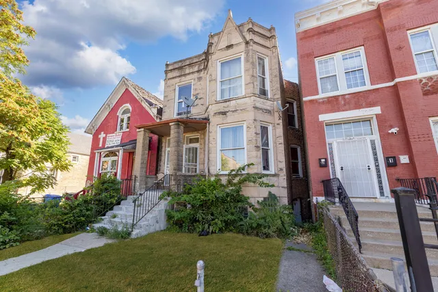a view of a brick building next to a yard