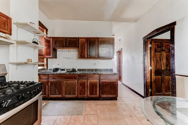 a kitchen with stainless steel appliances granite countertop a stove and a refrigerator