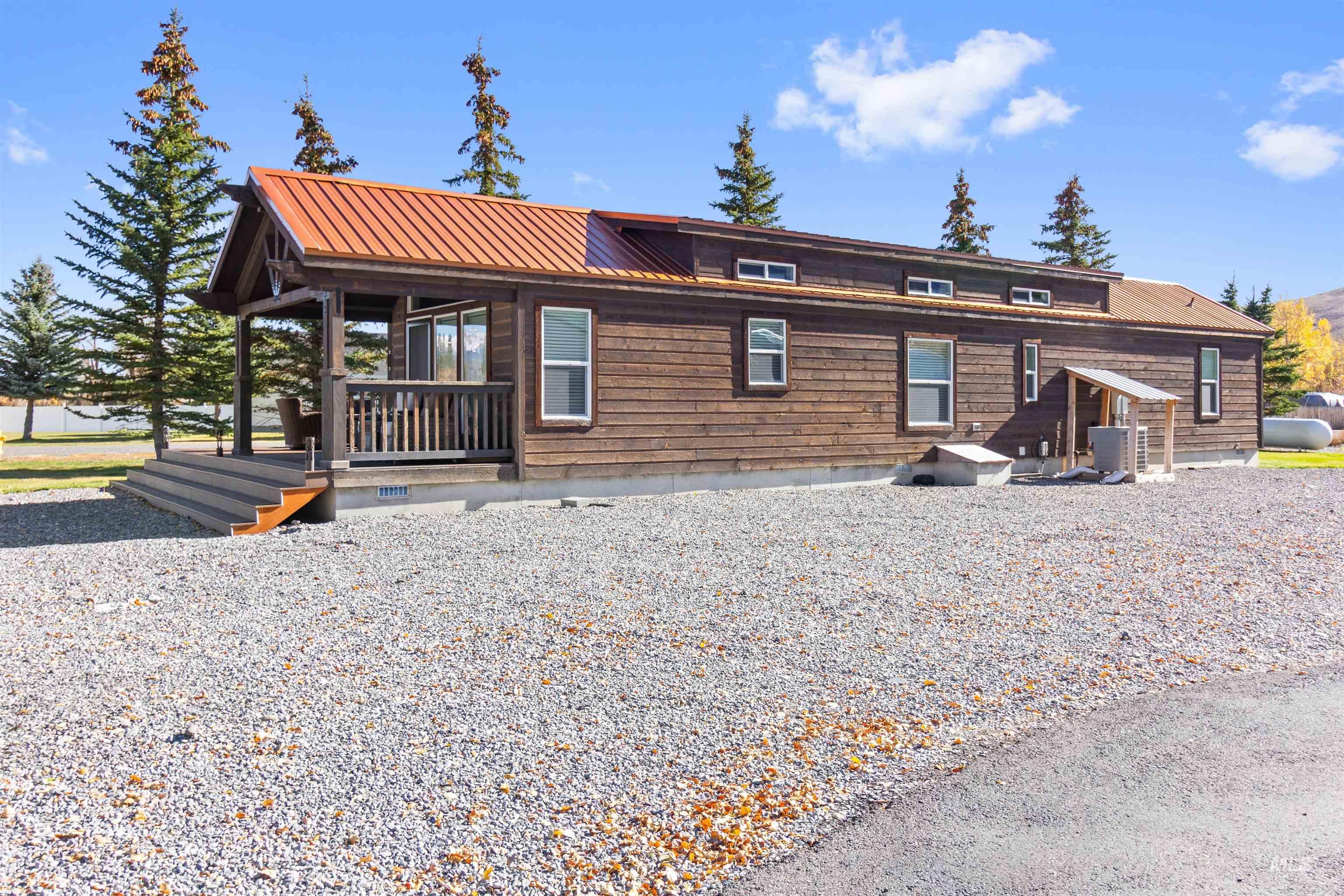 107 Willow Street Mackay, ID 83251 - Photo 22 of 48 View of front of property featuring a metal roof, crawl space, and covered porch