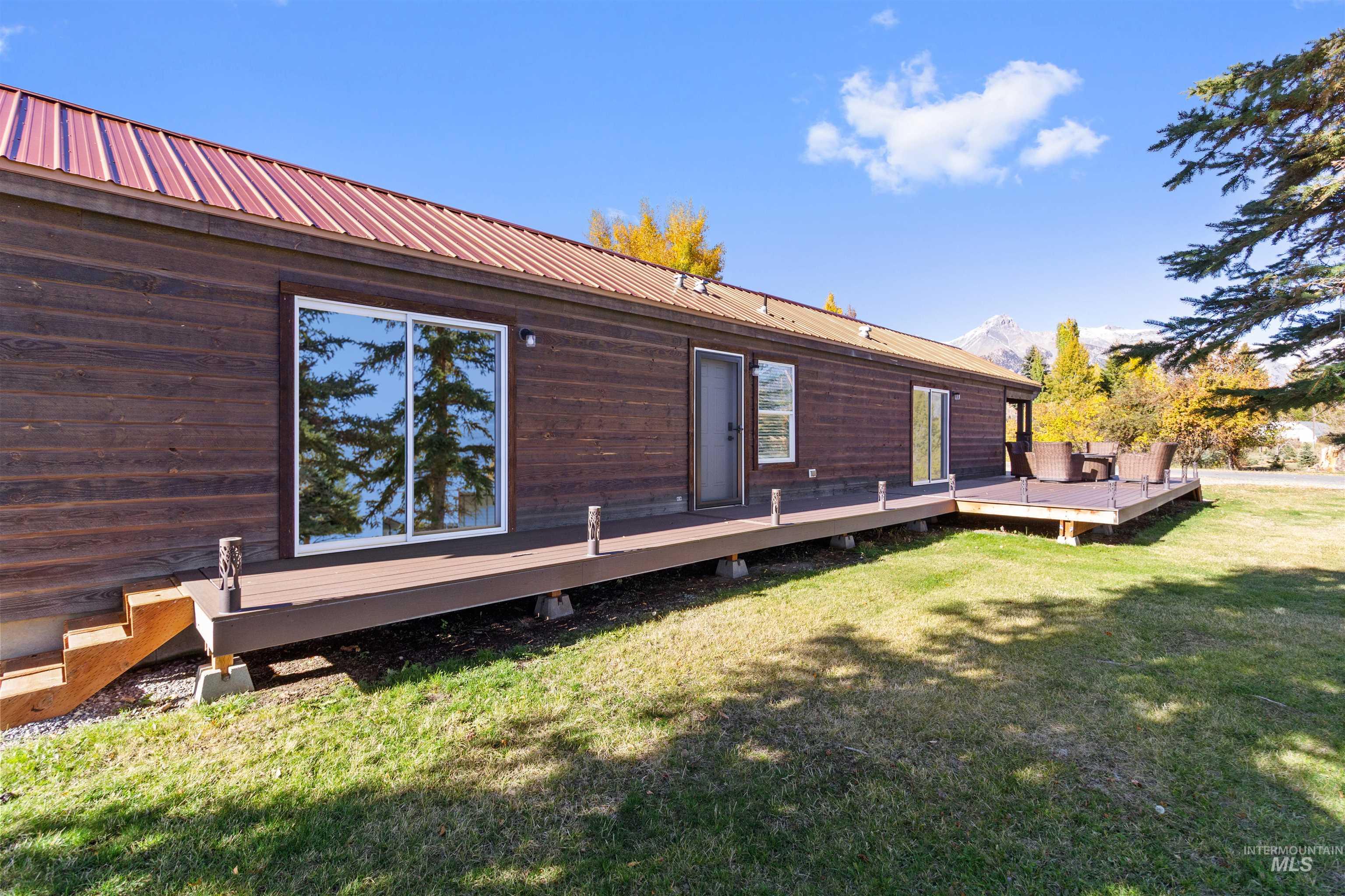 107 Willow Street Mackay, ID 83251 - Photo 23 of 48 Rear view of house with a deck, a lawn, and a metal roof