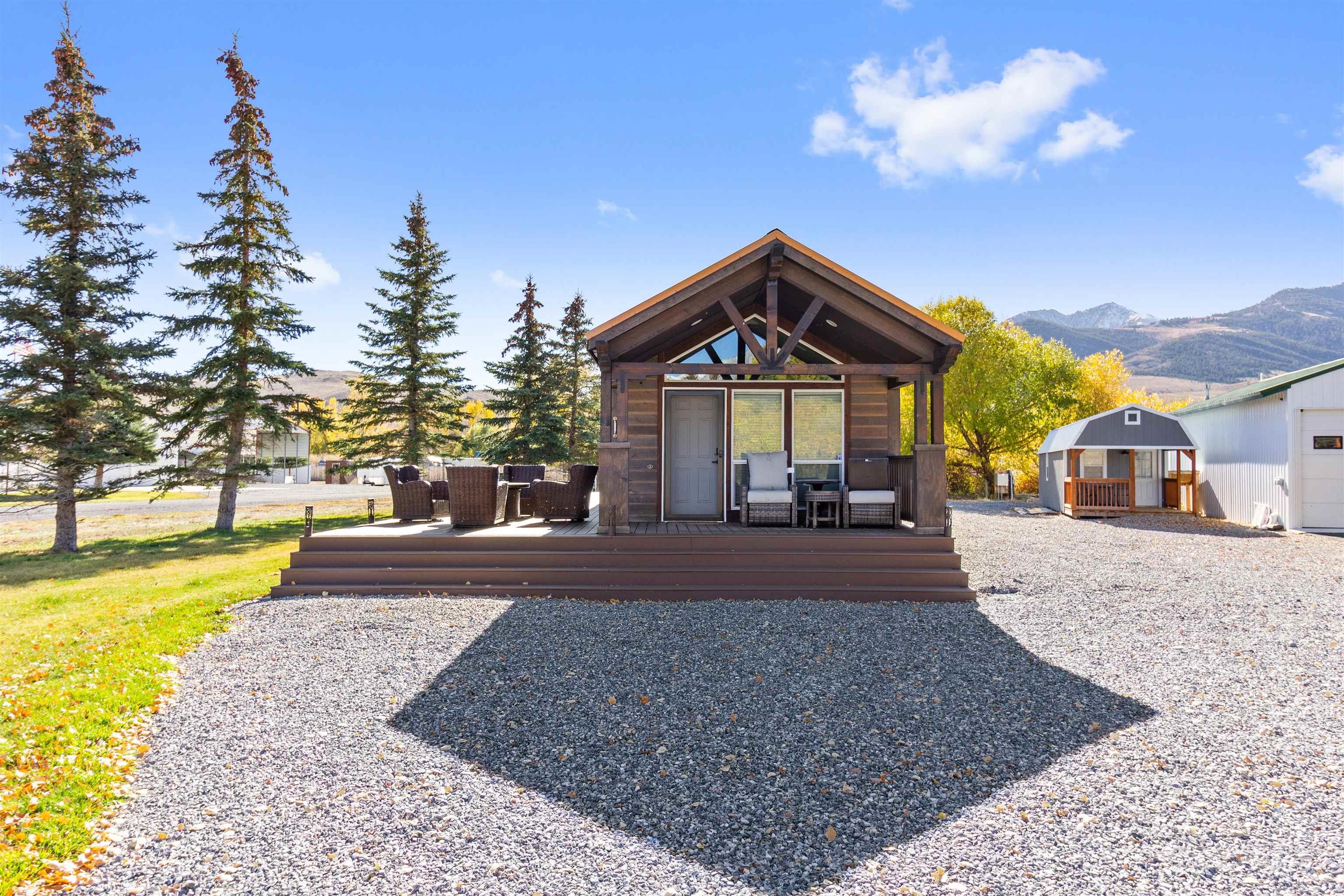 107 Willow Street Mackay, ID 83251 - Photo 5 of 48 Rear view of property featuring a deck with mountain view and an outdoor structure