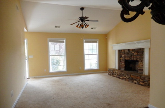 1030 Teagle Road Jackson, GA 30233 - Photo 5 of 7 a view of an empty room with a fireplace and a window