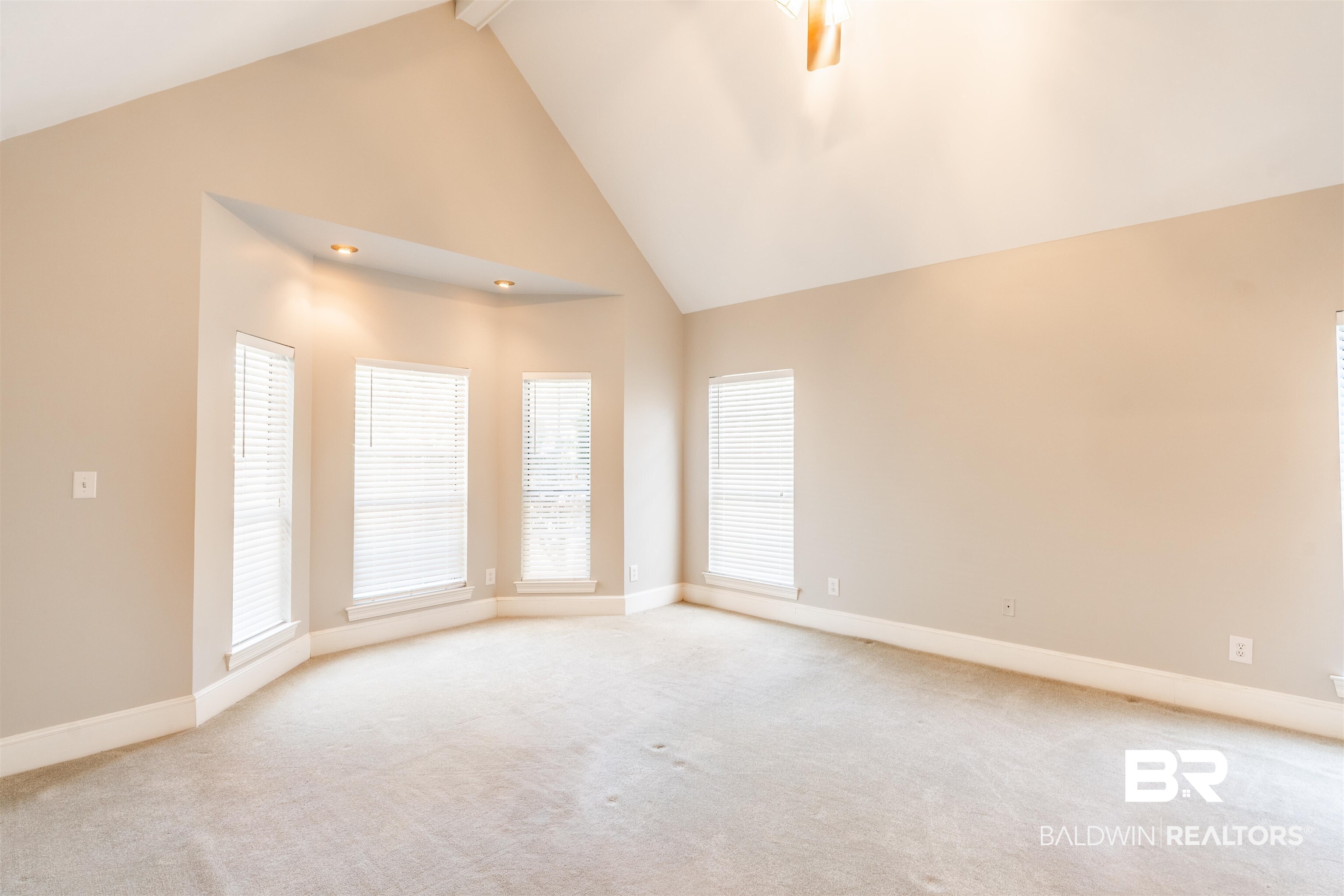 3821 St Andrews Loop East Mobile, AL 36693 - Photo 25 of 41 Carpeted spare room with high vaulted ceiling