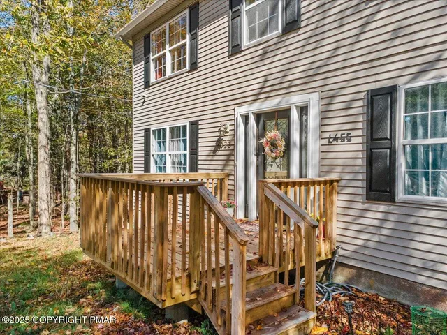an aerial view of a residential houses covered in trees