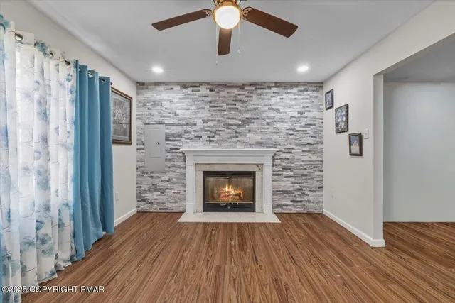 a room with a fireplace and wooden floor