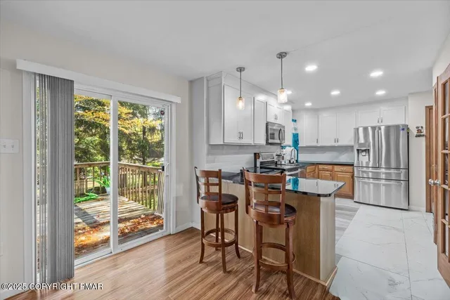 a view of a kitchen with dining table and chairs