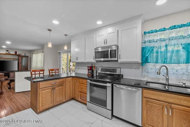 a kitchen with a sink stove and microwave