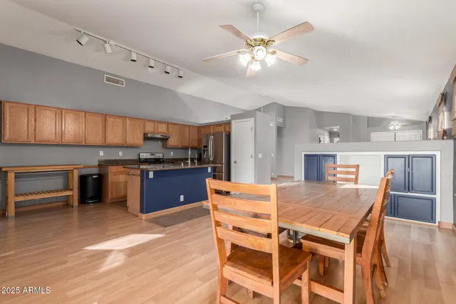 a large kitchen with a table and chairs