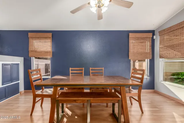 a view of a dining room with furniture wooden floor and a chandelier