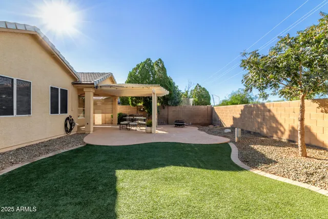 a view of a house with backyard porch and sitting area
