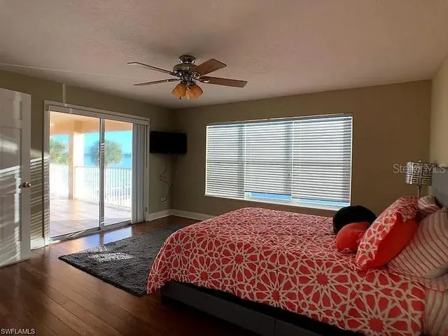 a bedroom with a large bed and a window