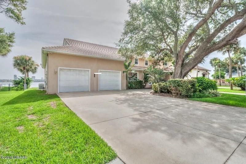 1647 Riverside Drive Daytona Beach, FL 32117 - Photo 4 of 29 a front view of a house with a yard and garage
