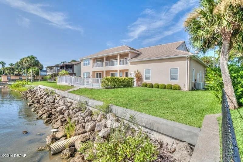 1647 Riverside Drive Daytona Beach, FL 32117 - Photo 6 of 29 a front view of a house with a yard and potted plants