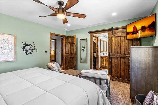 a bedroom with a bed and a chandelier