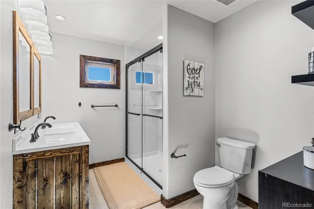 a bathroom with a sink toilet and shower
