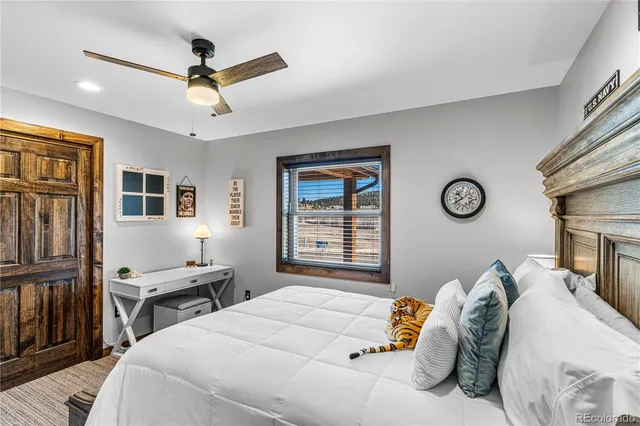 a bedroom with a bed and a chandelier