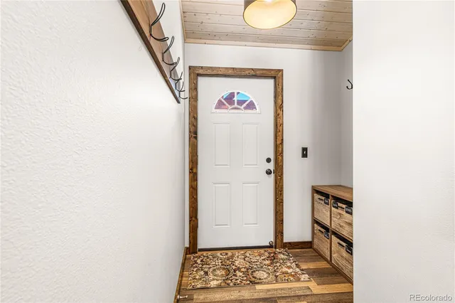 a view of hallway with wooden floor