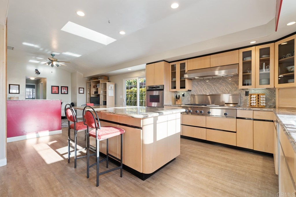 1754 Crest Drive Encinitas, CA 92024 - Photo 16 of 43 a kitchen with stainless steel appliances granite countertop a stove and cabinets