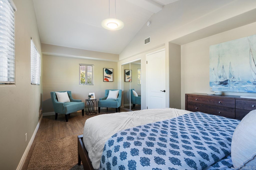 1754 Crest Drive Encinitas, CA 92024 - Photo 22 of 43 a bedroom with a large bed and a chandelier