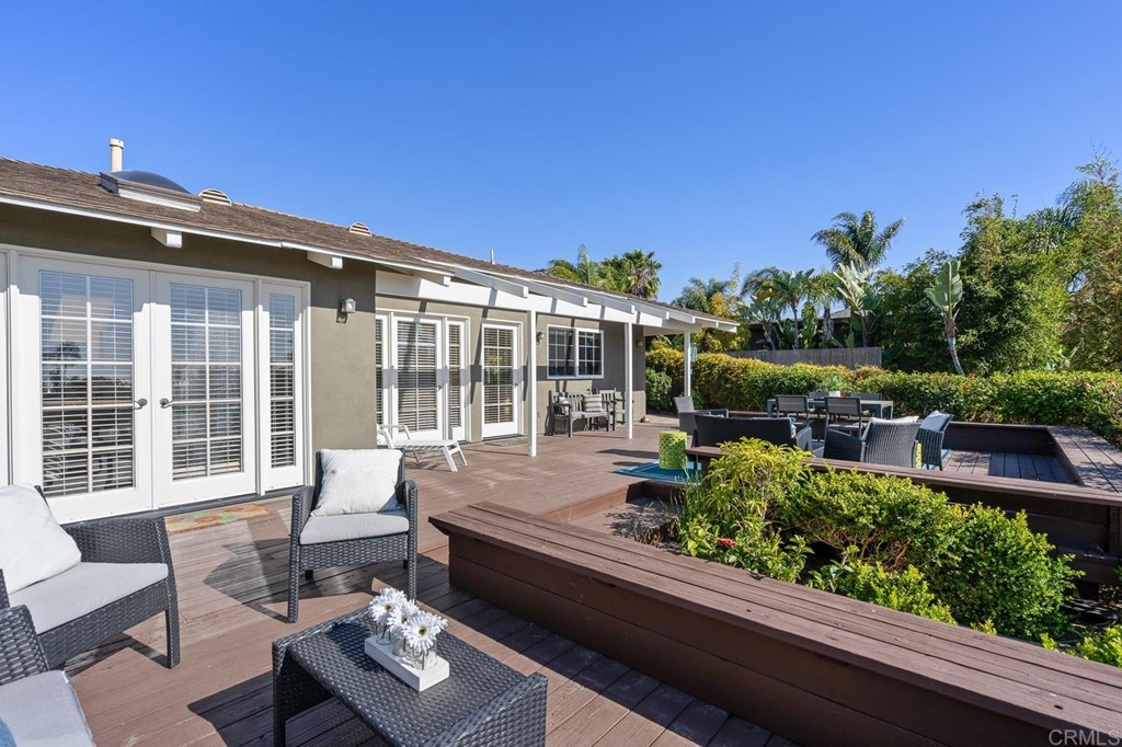 1754 Crest Drive Encinitas, CA 92024 - Photo 27 of 43 a roof deck with table and chairs and potted plants