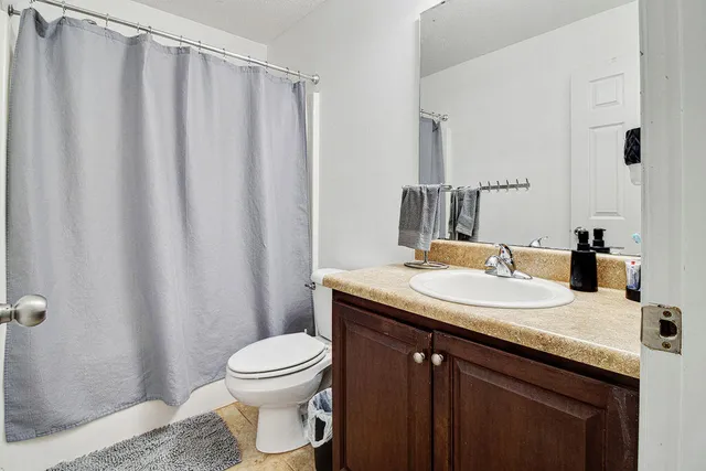 a bedroom with a bed and a ceiling fan