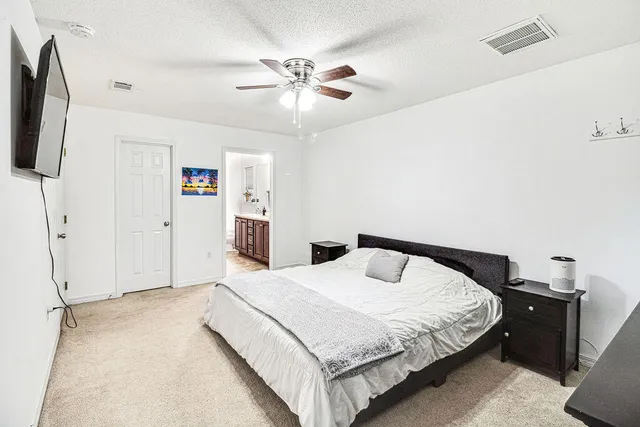 a bathroom with a granite countertop double vanity sink and mirror