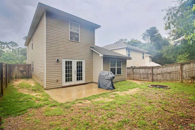 a front view of a house with a yard and seating space